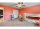 Cozy bedroom featuring a playful design, ceiling fan, and plush carpeting at 7828 Stone Forest St, North Las Vegas, NV 89084