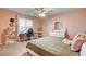 Comfortable bedroom featuring a ceiling fan, plush carpeting, and lots of natural light at 7828 Stone Forest St, North Las Vegas, NV 89084
