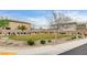 Park area with manicured lawn, sidewalks, mature trees, benches and landscaped rockery at 7828 Stone Forest St, North Las Vegas, NV 89084