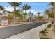 Community entrance with gate, professional landscaping, and manicured shrubs at 7828 Stone Forest St, North Las Vegas, NV 89084