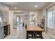 Open dining room with a rustic wood table, six chairs, and views of the kitchen and backyard at 7828 Stone Forest St, North Las Vegas, NV 89084