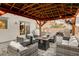 This backyard gazebo features a seating area, fans, and lighting to create a cozy outdoor atmosphere at 7828 Stone Forest St, North Las Vegas, NV 89084