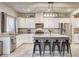 Well-lit kitchen featuring white cabinets, stainless steel appliances, and a center island with barstool seating at 7828 Stone Forest St, North Las Vegas, NV 89084