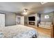 Relaxing main bedroom with ceiling fan, electric fireplace, and comfortable seating at 7828 Stone Forest St, North Las Vegas, NV 89084