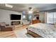 Comfortable bedroom with fireplace, wooden floors, and a ceiling fan at 7828 Stone Forest St, North Las Vegas, NV 89084