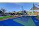 Modern community playground featuring climbing structure, slide, and covered play area at 7828 Stone Forest St, North Las Vegas, NV 89084