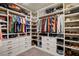 Spacious walk-in closet with custom shelving, drawers, and ample storage for clothes and shoes at 7828 Stone Forest St, North Las Vegas, NV 89084
