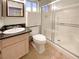 Bright bathroom features a shower with glass doors, modern vanity, and neutral tones at 8032 Astrology Ct # 201, Las Vegas, NV 89128