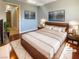 Modern bedroom featuring a wood platform bed, stylish decor, and hardwood floors at 8032 Astrology Ct # 201, Las Vegas, NV 89128