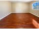 Spacious bedroom featuring hardwood flooring and a window for natural lighting at 8032 Astrology Ct # 201, Las Vegas, NV 89128