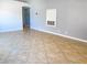 Spacious open concept living area with neutral paint, tile flooring and lots of natural light at 8032 Astrology Ct # 201, Las Vegas, NV 89128