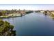 Scenic aerial view of a community lake with lush greenery, swimming pool, and surrounding homes at 8032 Marbella Cir, Las Vegas, NV 89128