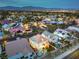 Fantastic aerial view of a home and community showcasing a waterway, city views, and beautiful mountain views at 8032 Marbella Cir, Las Vegas, NV 89128