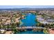 Expansive aerial view of a community lake surrounded by lush greenery and residential homes at 8032 Marbella Cir, Las Vegas, NV 89128
