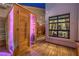An outdoor sauna on a wooden deck with a view into a light-filled living room at 8032 Marbella Cir, Las Vegas, NV 89128