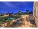Balcony with golf course views, comfortable seating and lush landscaping at dusk at 8032 Marbella Cir, Las Vegas, NV 89128