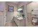 Bright bathroom featuring a modern vanity, a large mirror, and a separate toilet room at 8032 Marbella Cir, Las Vegas, NV 89128