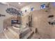 Luxurious bathroom featuring an elevated soaking tub, glass shower, and stylish modern accents at 8032 Marbella Cir, Las Vegas, NV 89128