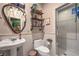 This bathroom features decorative lighting and tiled shower at 8032 Marbella Cir, Las Vegas, NV 89128