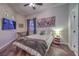 This bedroom includes a ceiling fan, art and television at 8032 Marbella Cir, Las Vegas, NV 89128