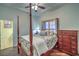 This cozy bedroom features a four poster bed and wood-look flooring at 8032 Marbella Cir, Las Vegas, NV 89128