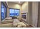 Cozy bedroom nook featuring built-in shelving, a fireplace, and three large windows offering neighborhood views at 8032 Marbella Cir, Las Vegas, NV 89128