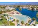 Aerial view of a community pool with palm trees and blue umbrellas, perfect for relaxation at 8032 Marbella Cir, Las Vegas, NV 89128