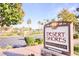 Entrance to the Desert Shores Clubhouse & Lagoon, a private community with lush landscaping at 8032 Marbella Cir, Las Vegas, NV 89128