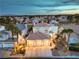 Exterior shot of a home featuring a three-car garage and mature landscaping at 8032 Marbella Cir, Las Vegas, NV 89128