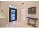 Bright and inviting foyer featuring elegant tile flooring, decorative door, and stylish console table with modern decor at 8032 Marbella Cir, Las Vegas, NV 89128