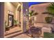 Inviting front entrance with a decorative door, manicured landscaping, and a charming courtyard, creating a warm welcome at 8032 Marbella Cir, Las Vegas, NV 89128
