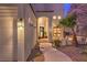 Elegant home entrance with a well-lit walkway, lush landscaping, and a welcoming front door, creating great curb appeal at 8032 Marbella Cir, Las Vegas, NV 89128