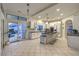 Bright kitchen featuring a large island with bar seating, stainless steel appliances and sliding glass doors at 8032 Marbella Cir, Las Vegas, NV 89128
