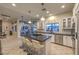 Well-lit kitchen with a large island, white cabinets, barstool seating and stainless steel appliances at 8032 Marbella Cir, Las Vegas, NV 89128