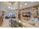 Bright living room featuring high ceilings, tiled floors, distinctive wallpaper, and a cozy sectional at 8032 Marbella Cir, Las Vegas, NV 89128