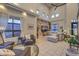 Cozy living area with high ceilings, eclectic wallpaper, comfortable seating, and natural light at 8032 Marbella Cir, Las Vegas, NV 89128