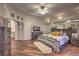 A spacious bedroom with wood floors, ceiling fan, and a king bed in front of mirrored wall decor at 8032 Marbella Cir, Las Vegas, NV 89128