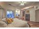 Spacious bedroom features wood floors, ceiling fan, a fireplace and access to outdoor balcony at 8032 Marbella Cir, Las Vegas, NV 89128