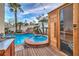 Luxurious pool and spa with beautiful rock waterfall, surrounded by palm trees and a sauna, perfect for relaxation at 8032 Marbella Cir, Las Vegas, NV 89128