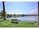 Picturesque waterfront view with clear blue water, lush green grass, and a tranquil setting at 8032 Marbella Cir, Las Vegas, NV 89128