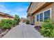 Exterior back yard with walkway leading to sitting area at 8102 Villa De La Playa St, Las Vegas, NV 89131