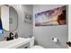 Modern half bathroom with stylish vanity and an eye catching light fixture at 8102 Villa De La Playa St, Las Vegas, NV 89131