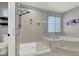 Spacious bathroom with glass shower, soaking tub, and tile flooring at 8102 Villa De La Playa St, Las Vegas, NV 89131