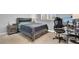 Bedroom featuring modern furniture, neutral tones, and natural light from shuttered windows and a gaming chair and desk at 8102 Villa De La Playa St, Las Vegas, NV 89131