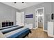 Comfortable bedroom featuring wood floors and easy bathroom access at 8102 Villa De La Playa St, Las Vegas, NV 89131