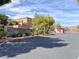 View of Stone Mountain community entrance with stone sign, landscaping, and gated access for security at 8102 Villa De La Playa St, Las Vegas, NV 89131