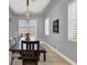Elegant dining room featuring a modern light fixture, neutral decor, and ample natural light at 8102 Villa De La Playa St, Las Vegas, NV 89131
