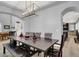 Elegant dining room with a large table, bench seating, and modern chandelier, perfect for entertaining at 8102 Villa De La Playa St, Las Vegas, NV 89131
