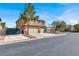 A two-story home with a three-car garage and a well-kept lawn on a corner lot at 8102 Villa De La Playa St, Las Vegas, NV 89131