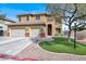 Charming two-story home featuring a manicured lawn, three-car garage, and inviting front entrance at 8102 Villa De La Playa St, Las Vegas, NV 89131